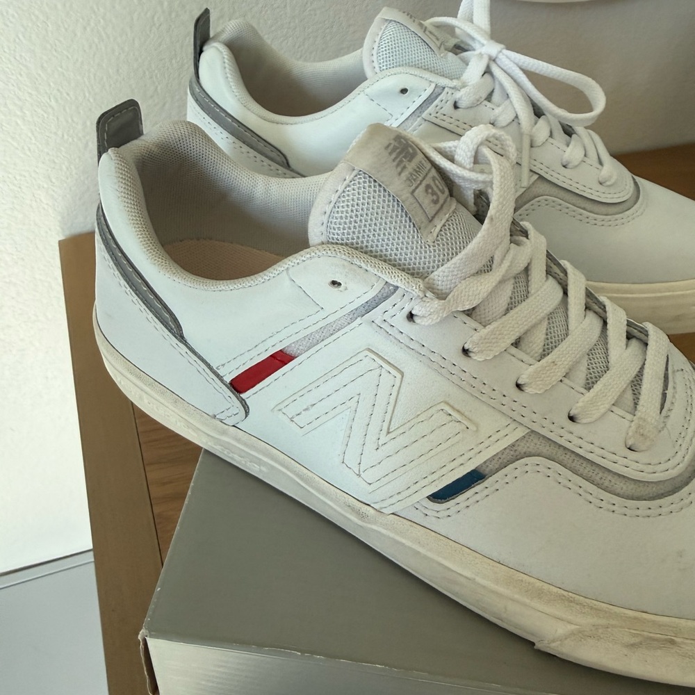 New Balance White Low-Top Sneakers with Red & Blue Accents